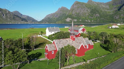 Landscape with a view of Flakstad Church in Flakstad, with the peaks of the mountains Blekktinden and Digertinden in the background, among others. Lofoten district in Norway