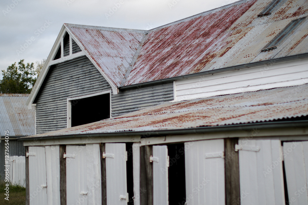 Old weathered work shed with timber doors and corrugated iron roofs Old weathered work shed with timber doors and corrugated iron roofs