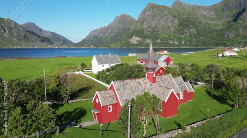 Landscape with a view of Flakstad Church in Flakstad, with the peaks of the mountains Blekktinden and Digertinden in the background, among others. Lofoten district in Norway