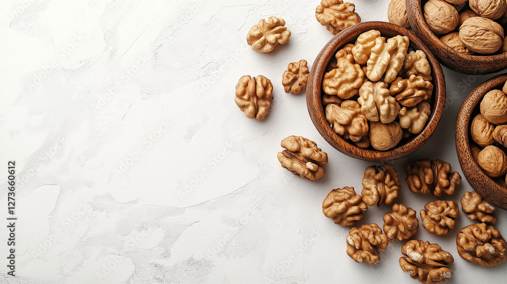 A beautiful arrangement features bowls filled with both shelled and unshelled walnuts, creating an inviting display on a light and textured surface, perfect for a healthy snack A beautiful arrangement features bowls filled with both shelled and unshelled walnuts, creating an inviting display on a light and textured surface, perfect for a healthy snack