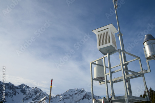 Alpine weather station against a blue sky photo