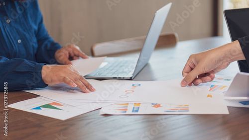 business collaboration, financial analysis, and teamwork, professionals reviewing financial reports and discussing data. The workspace, charts, and strategic documents, a corporate and analytical