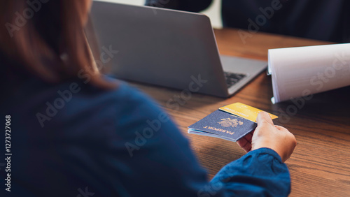 Obraz na płótnie the concept of travel, finance, and identity verification, a close-up of hands exchanging a passport and a credit card, and documents international transactions, border security, and business travel. w salonie
