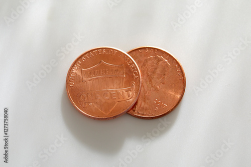 Two pennies on white background