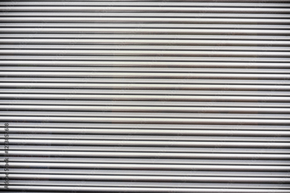 Closed shutter in front of shop Closed shutter in front of shop