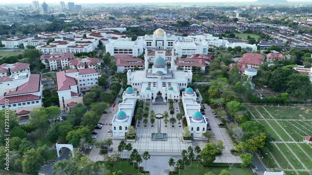 Aerial view of Masjid AlBukhary in Alor Setar, Malaysia – stunning Islamic architecture with blue domes, symmetrical design, and surrounding greenery. Aerial view of Masjid AlBukhary in Alor Setar, Malaysia – stunning Islamic architecture with blue domes, symmetrical design, and surrounding greenery.