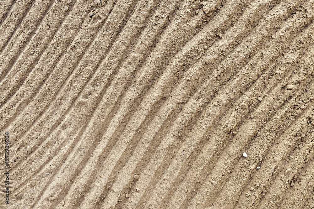 Beach sand pattern as background with natural wave. Natural sand beach sand texture in summer sun. Top view. Beach sand pattern as background with natural wave. Natural sand beach sand texture in summer sun. Top view.