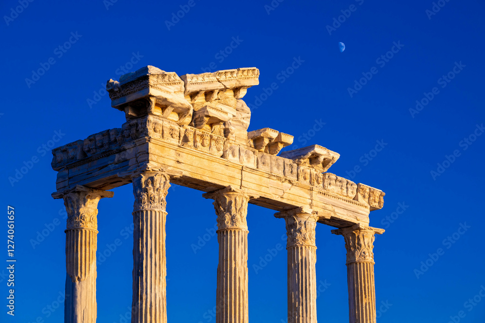 Temple of Apollo at sunset with a crescent moon in the sky above it. The temple was built in the 2nd century AD during the Roman Empire. Side, Manavgat, Antalya province, Turkey Temple of Apollo at sunset with a crescent moon in the sky above it. The temple was built in the 2nd century AD during the Roman Empire. Side, Manavgat, Antalya province, Turkey