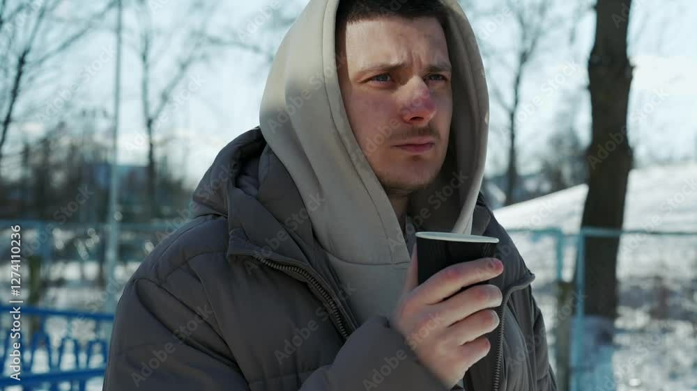 A man drinks a hot drink on the street in winter.
Hot drink in a glass in the cold.
Frosty weather outside.
A man warms himself with warm tea in winter.
Steam from a glass in the cold.
Tea, frost A man drinks a hot drink on the street in winter.
Hot drink in a glass in the cold.
Frosty weather outside.
A man warms himself with warm tea in winter.
Steam from a glass in the cold.
Tea, frost