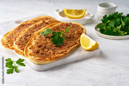 Meat with dough, manaqish meat, arabian flat bread with meat. Turkish lahmacun with minced meat . Close up