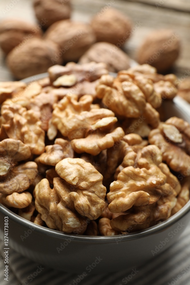 Fresh walnuts in bowl on table, closeup Fresh walnuts in bowl on table, closeup