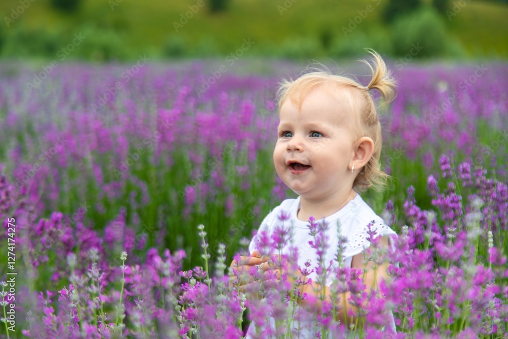 Little girl in a lavender field and touching the flowers with her hand. Little girl in a lavender field and touching the flowers with her hand.
