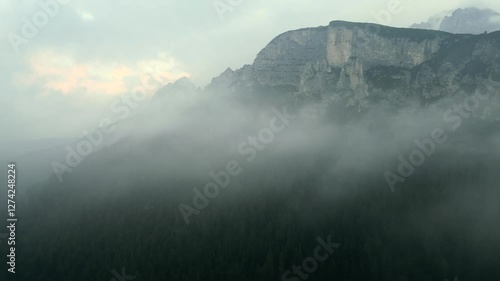 Aerial panoramic view of Dolomites Alps with impressive clouds in Italy