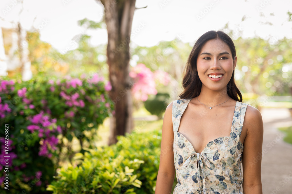 Young Asian woman walking in garden Young Asian woman walking in garden