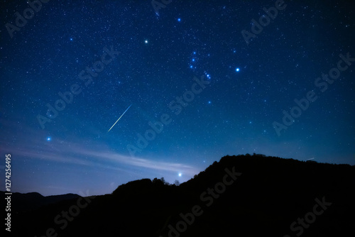 Obraz na płótnie Milky Way stars with Orionids meteor shower trails and countryside tree silhouettes. w salonie
