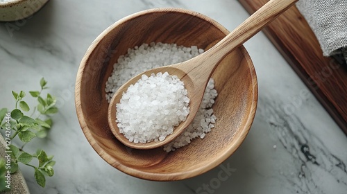 Wooden spoon resting on a bowl filled with Celtic sea salt crystals 