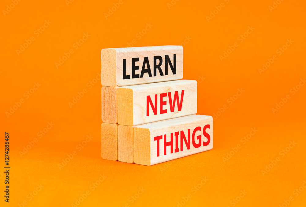 Naklejka premium Learn new things symbol. Concept words Learn new things on beautiful wooden blocks. Beautiful orange table orange background. Business motivational learn new things concept. Copy space.