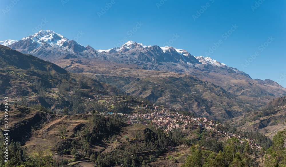 panoramic view of sorata town, mountain Ancohuma and mountain illampu, the third and fourth highest mountains in Bolivia in the andes mountain range with a blue sky illuminated with natural light panoramic view of sorata town, mountain Ancohuma and mountain illampu, the third and fourth highest mountains in Bolivia in the andes mountain range with a blue sky illuminated with natural light