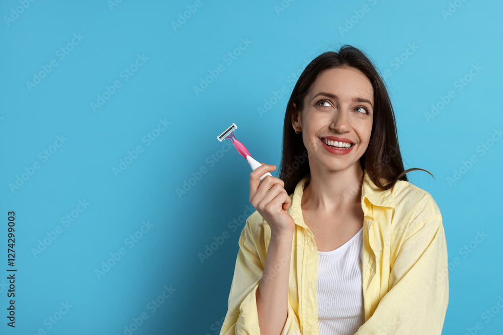 Happy woman with razor on light blue background, space for text. Hair removal tool Happy woman with razor on light blue background, space for text. Hair removal tool
