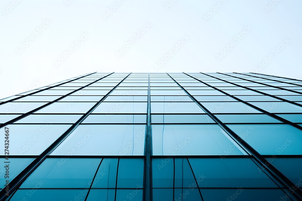 Obraz premium Modern Architectural Marvel: A striking architectural composition showcasing a contemporary skyscraper's glass facade, exuding a sense of sleek sophistication.