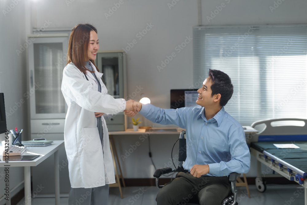 Fototapeta premium Female doctor shaking hands with a patient in a wheelchair in the hospital