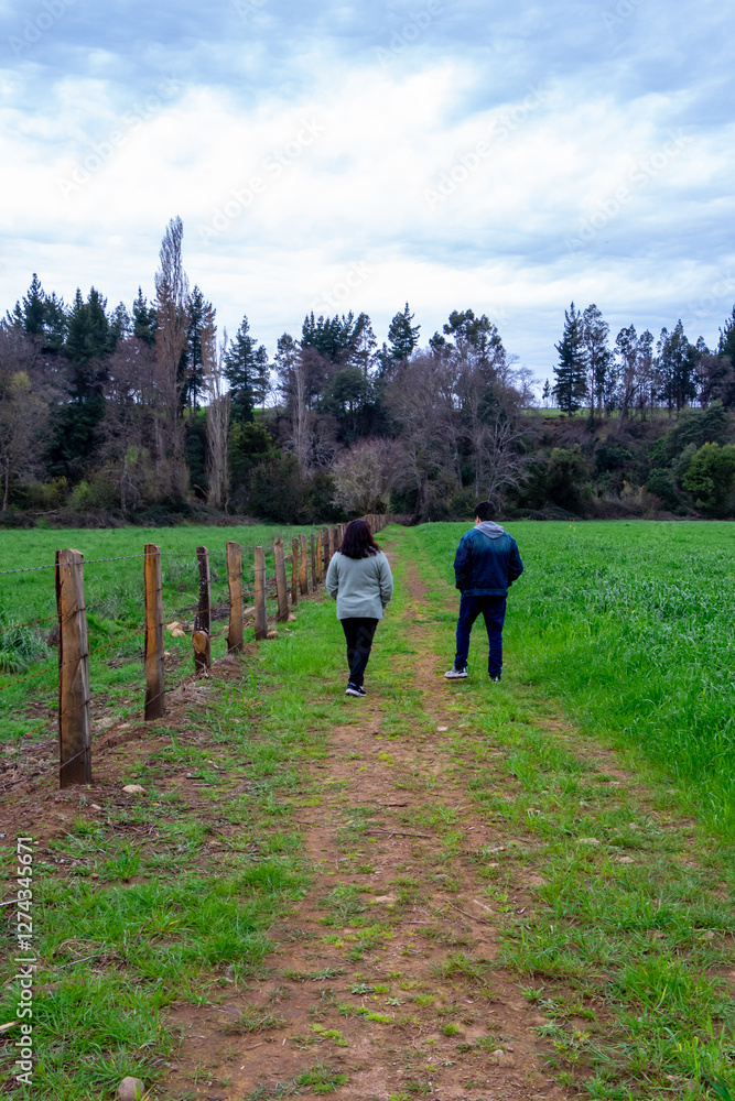 People, mother and son walking through a field in southern Chile after a rainy day, El Carmen, Ñuble, Chile People, mother and son walking through a field in southern Chile after a rainy day, El Carmen, Ñuble, Chile