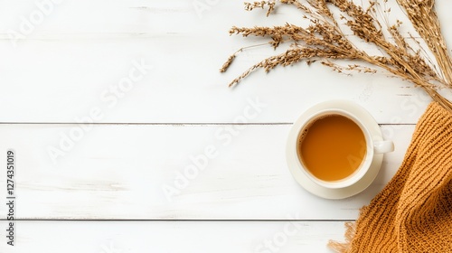 A white cup of coffee sits on a wooden table
