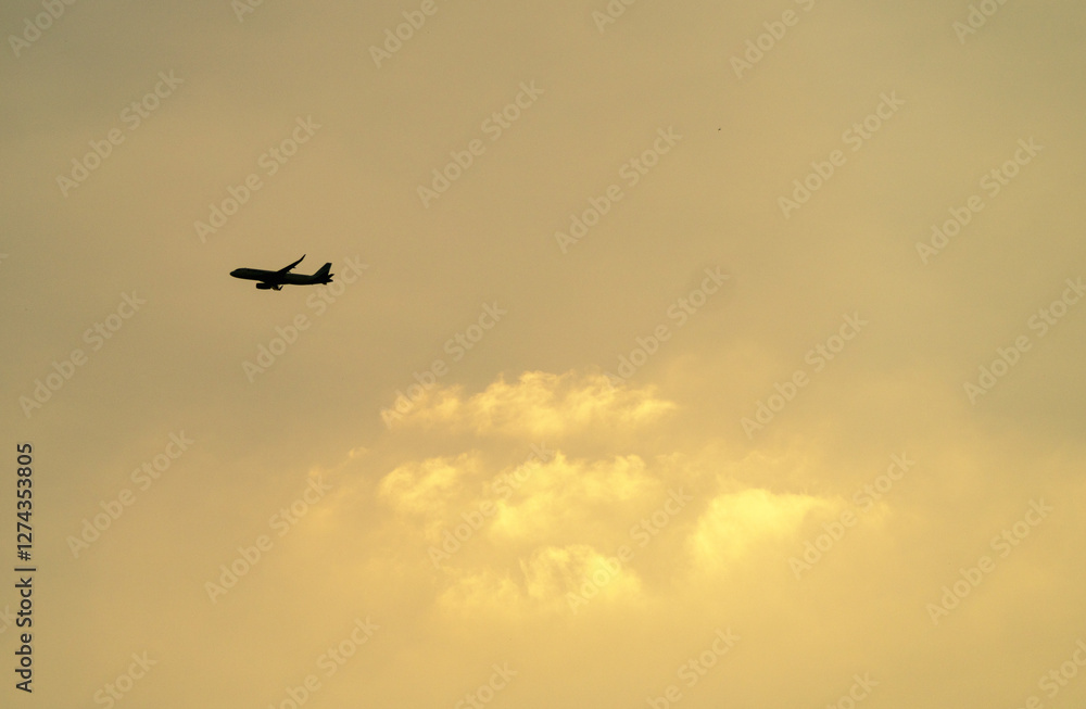 A plane flying over the golden clouds A plane flying over the golden clouds