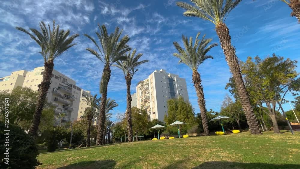 Residential area in Israel. New buildings, cozy neighborhoods, palm trees and white apartment buildings, residential real estate Residential area in Israel. New buildings, cozy neighborhoods, palm trees and white apartment buildings, residential real estate