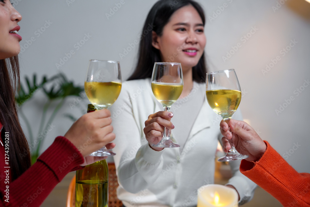 Friends toasting with white wine glasses during a party Friends toasting with white wine glasses during a party
