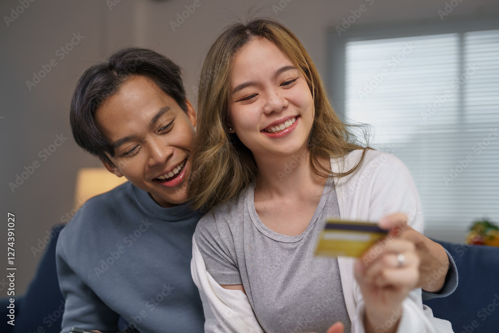 Fototapeta premium Happy couple buying online with credit card at home