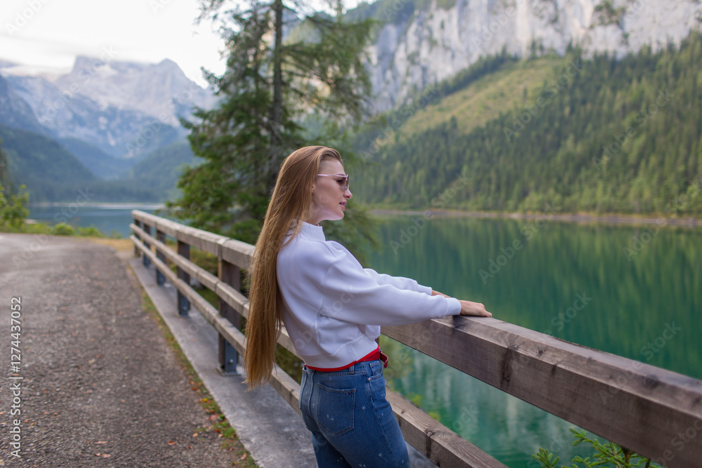 Woman Enjoying Scenic View by a Mountain Lake Woman Enjoying Scenic View by a Mountain Lake