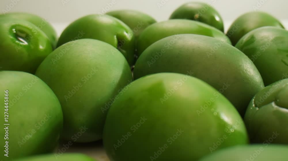 Pickled round green olives from Greece, close up of red black and green olive, fermented spanish salted food. Pickled round green olives from Greece, close up of red black and green olive, fermented spanish salted food.