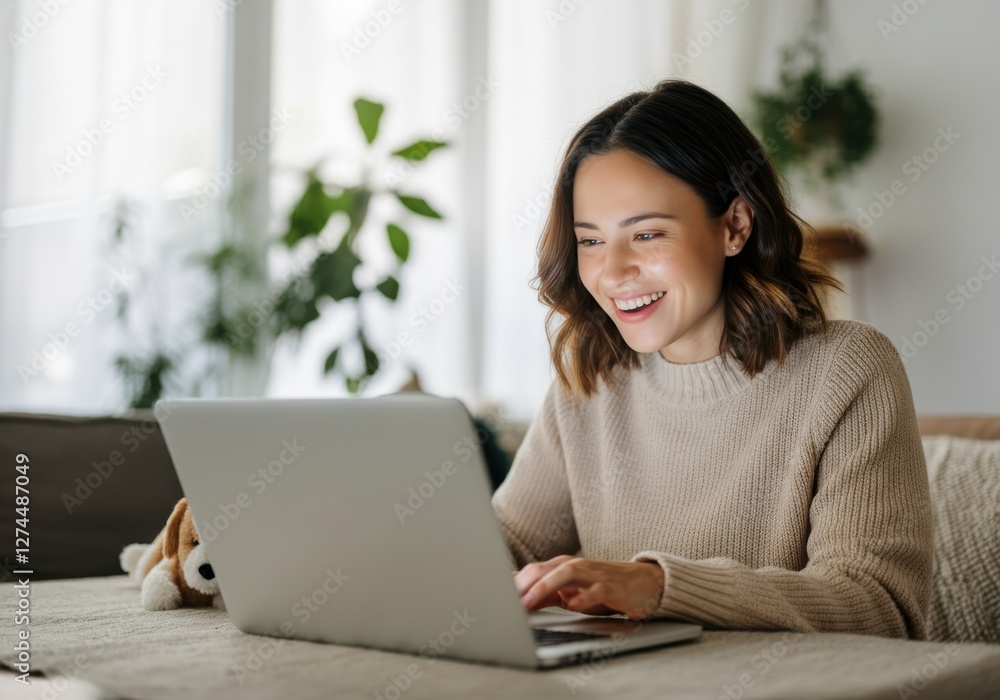 Smiling woman using a laptop at home, enjoying her online experience Smiling woman using a laptop at home, enjoying her online experience