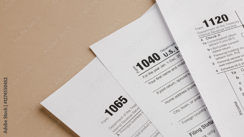 Obraz premium Tax Form Documents: A close-up view of various tax forms including 1040, 1065, and 1120, placed on a neutral-toned surface, ready for completion and filing.