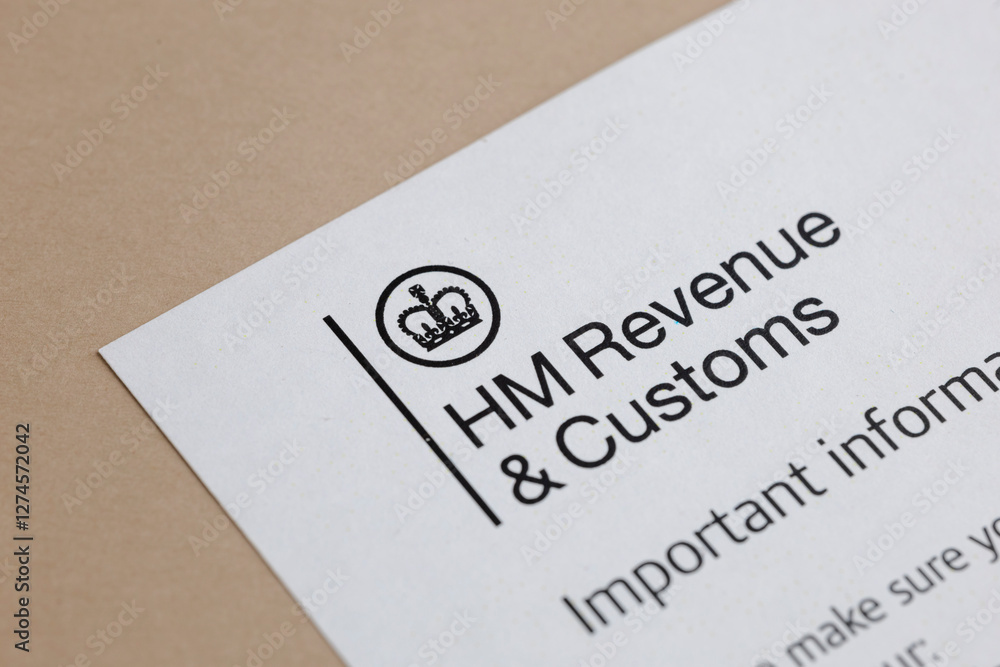 Close-up of a printed tax document. It shows tax office and a crown. The document is on a beige colored desk. It looks like a printed form. Close-up of a printed tax document. It shows tax office and a crown. The document is on a beige colored desk. It looks like a printed form.