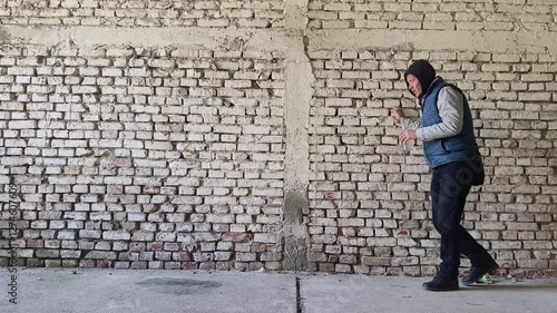 Drunk homeless man walk in abandoned ruined building