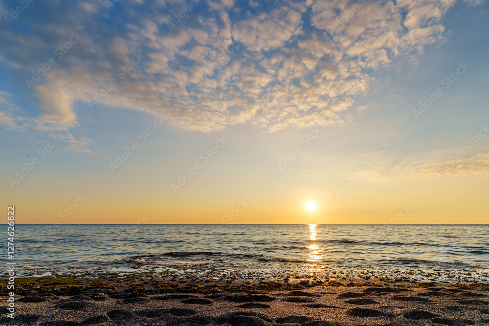 Tranquil Ocean Sunset With Reflective Waves and Soft Colorful Sky.. Tranquil Ocean Sunset With Reflective Waves and Soft Colorful Sky..