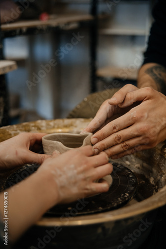 hands of a potter, making heart from glay