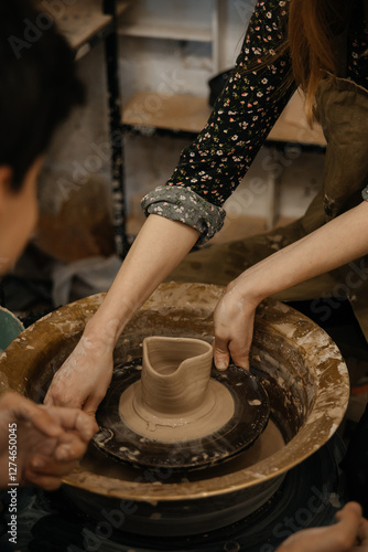 hands of a potter, making heart from glay