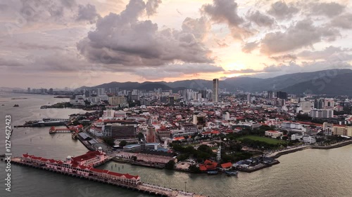 Penang Island, Malaysia drone video at sunset - Wide aerial view of George Town, Penang including Komtar Tower, Swettenham Pier Penang, Fort Cornwallis and more at dusk 