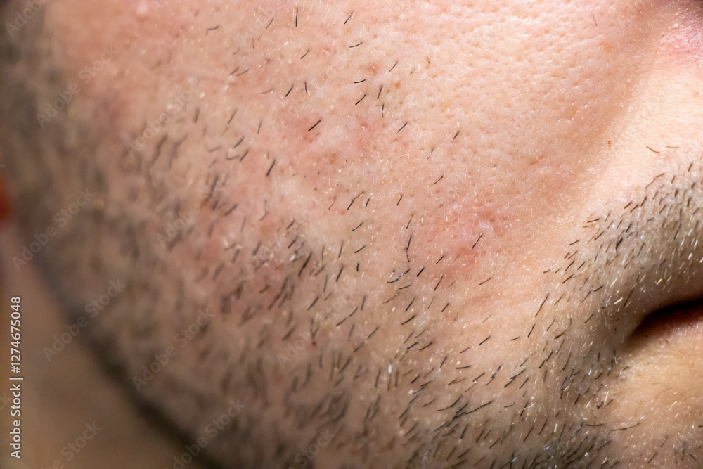 Naklejka premium Close-up view of facial hair and skin texture highlighting the natural look and grooming. Ideal for beauty and skincare concepts.