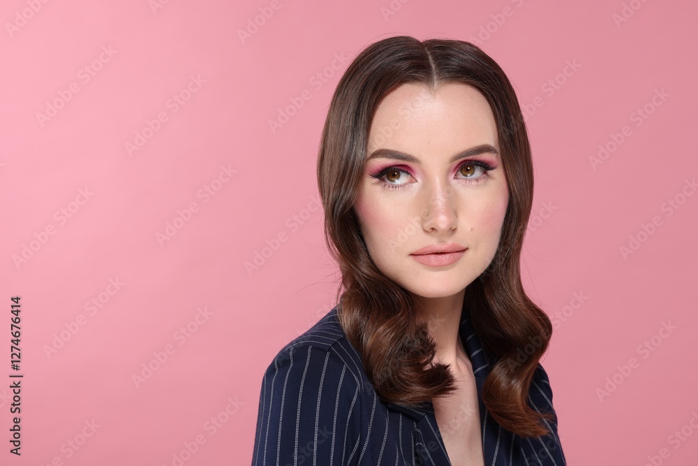 Fototapeta premium Portrait of beautiful young woman with stylish makeup and gorgeous hair on pink background. Space for text