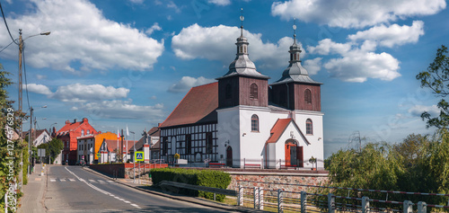 Summer cityscape of Skoki, Wielkopolskie, Poland. Catholic church (Kościół św. Mikołaja Biskupa w Skokach) in the foreground.
