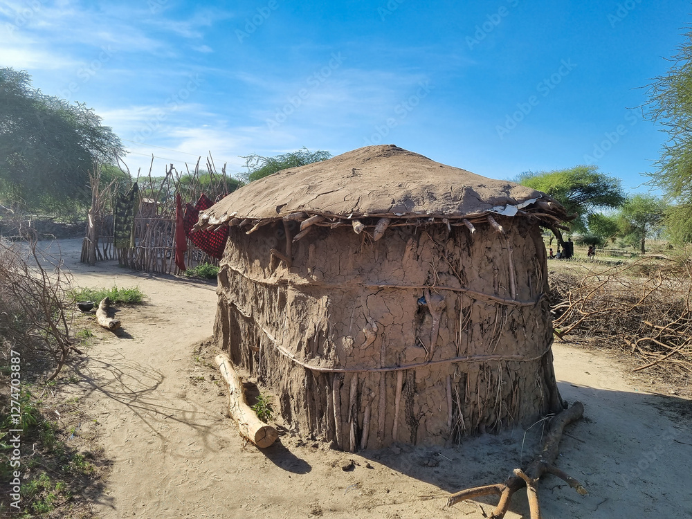 Fototapeta premium A Traditional Hut situated in a Beautiful Rural Landscape beneath a Clear Blue Sky maasai tarangire tanzania Africa