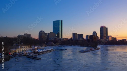 Boston city skyline with high-rise buildings seen from  Longfellow bridge over Charles river during winter sunset photo