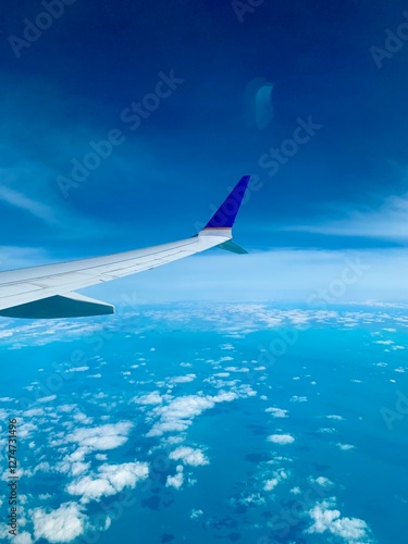 View from the airplane window on a beautiful sky and the wing of the airplane. Earth and sky as seen through an airplane window