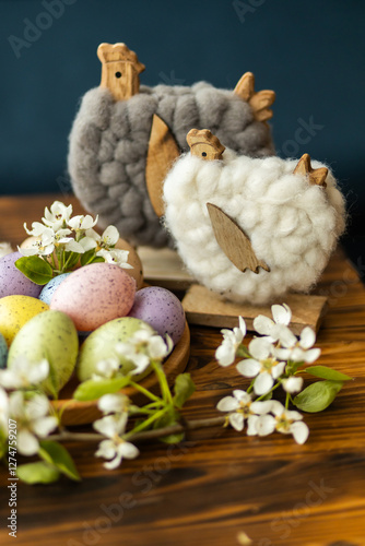 Easter decor with pastel eggs and woolen chickens on wood photo