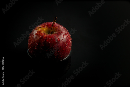 red apple on black background