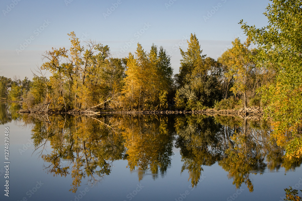 Perfect reflection in a beautiful autumn lake, surrounded by forest Perfect reflection in a beautiful autumn lake, surrounded by forest